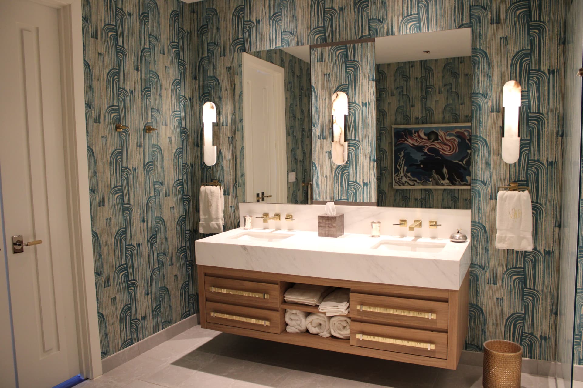 Bathroom with hand-painted blue-green wallpaper, a floating walnut vanity, brass fixtures, and a marble counter — Downtown Nashville, Nashville